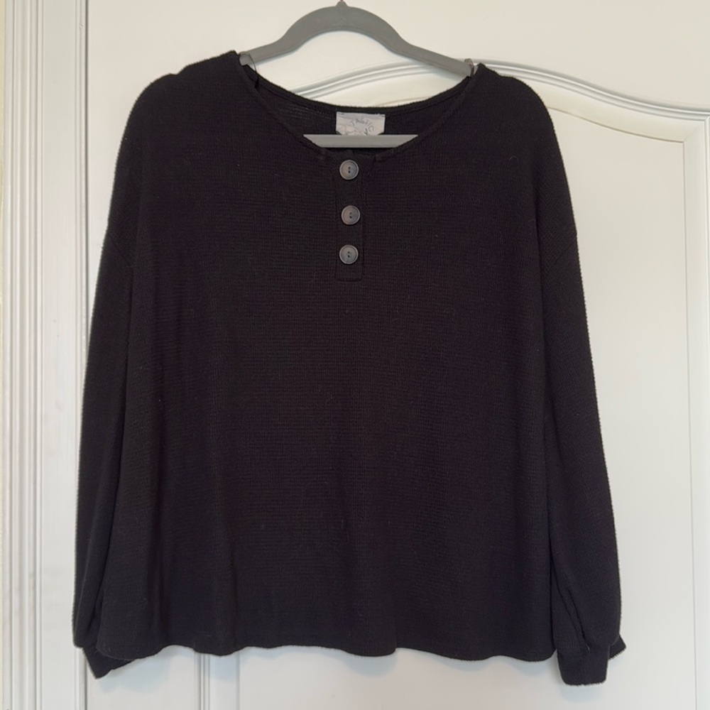 Size small black waffle knit top with button detail nd blousy sleeves.